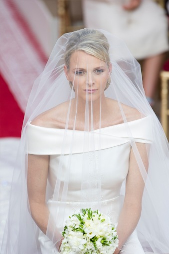 princess charlene of monaco with face veil seated during her wedding to prince albert